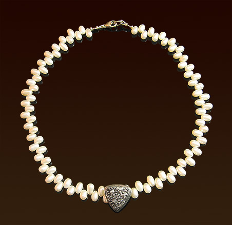 White dancing freshwater pearls necklace, sterling focal repousse' button, lobster clasp